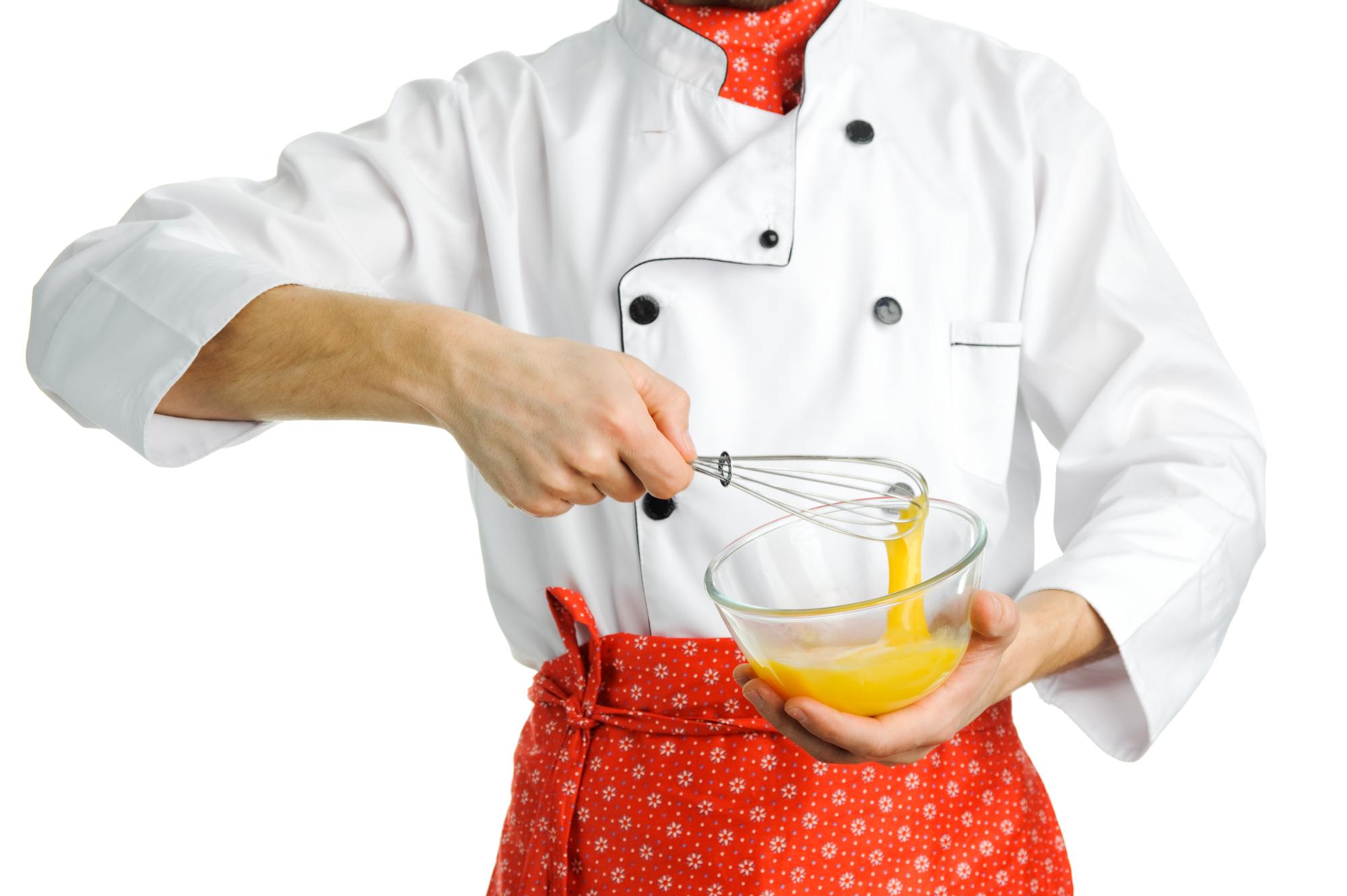 Close-up of hands seasoning a dish during workshop